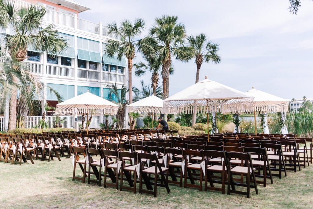 Guest seats under umbrellas for the wedding