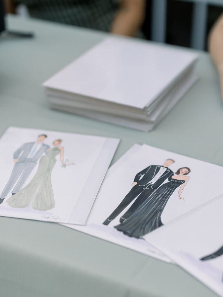 Illustrated wedding attire sketches on table