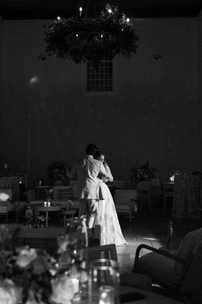 Bride and groom dancing in soft light